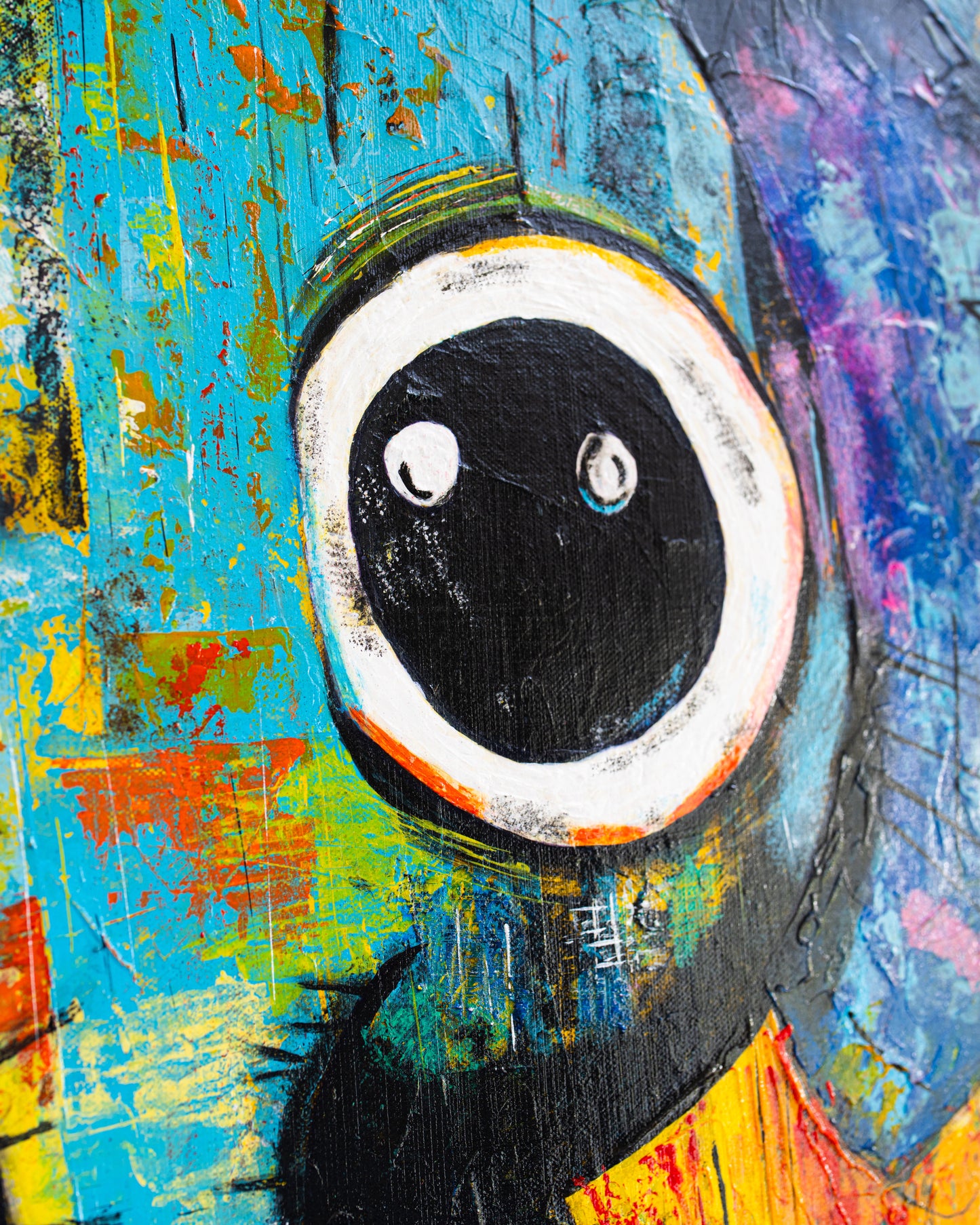 Abstract painting with a central black circle and white border on a multicolored background