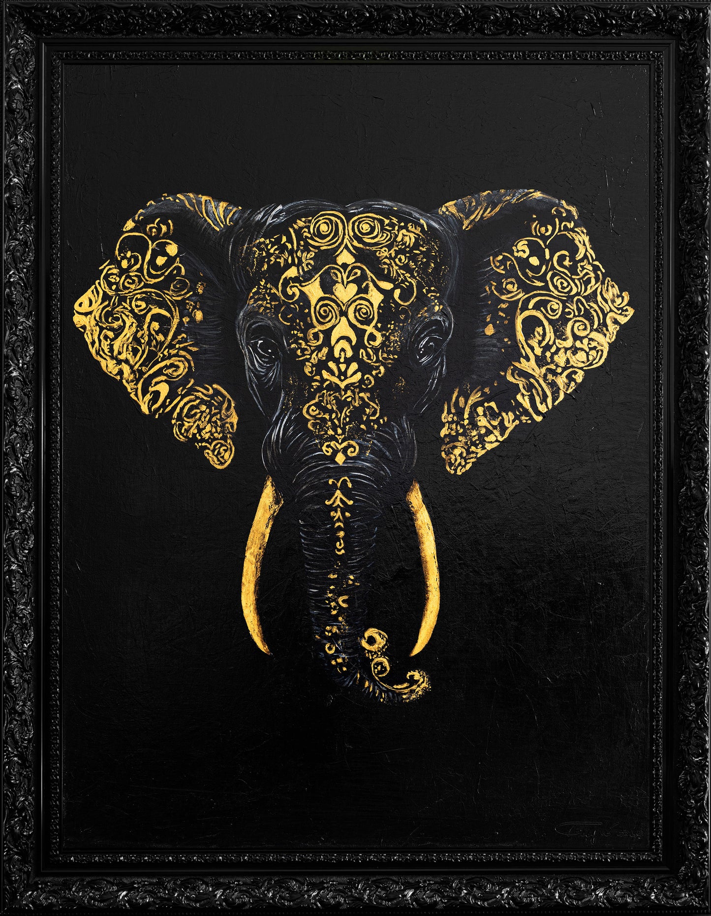 Decorative elephant head with gold patterns on a black background