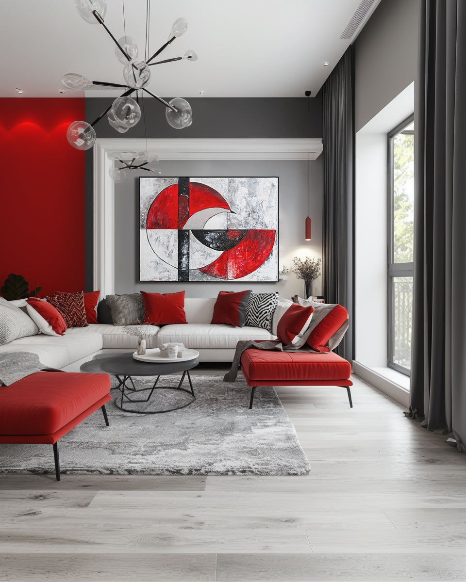 Modern living room with red and gray decor, including a sectional sofa and abstract art.